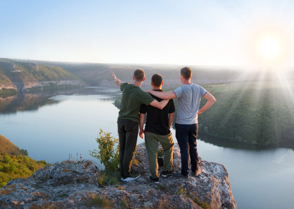 A group of men hiking as an aspect of experiential addiction treatment.