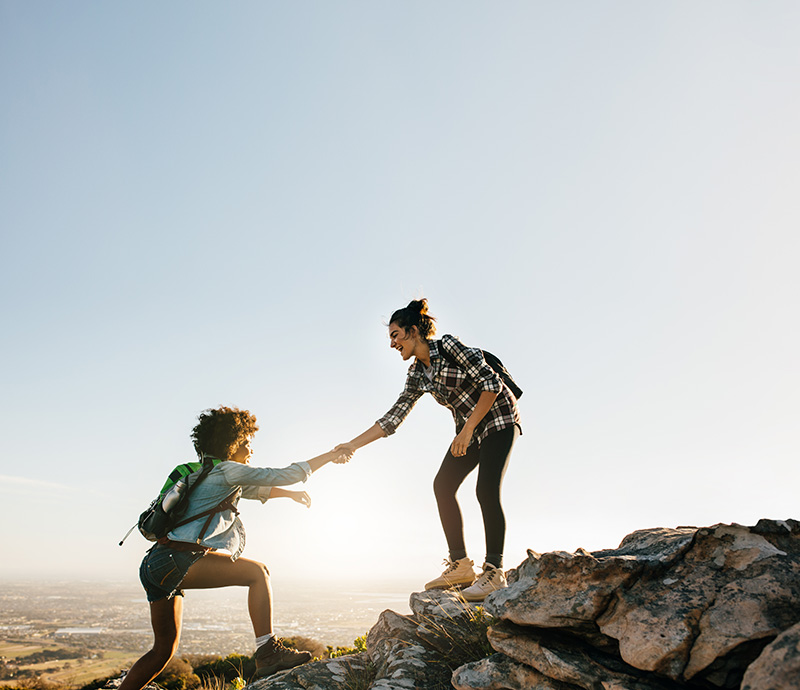 Two women go hiking, an experiential therapy for addiction treatment.