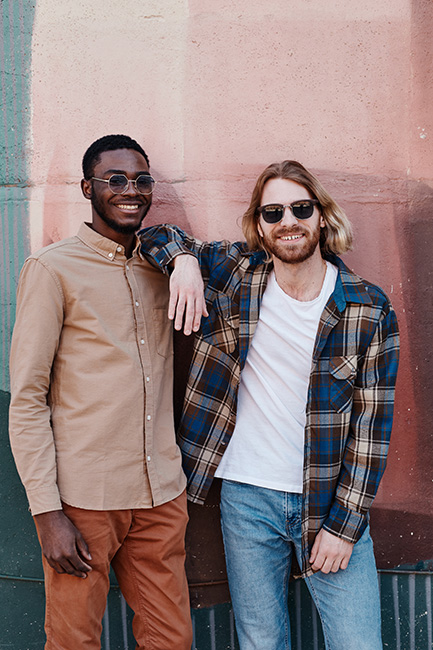 Two friends smile at the camera.