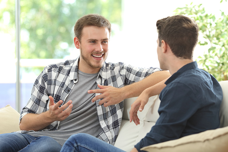 Two men talk during an addiction treatment program.