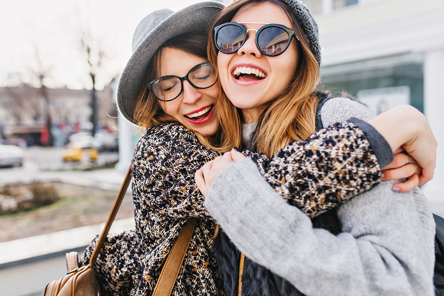 Two women laugh while walking around in Nashua, New Hampshire.