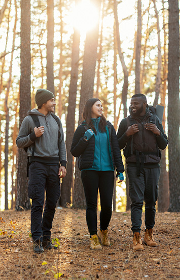 Three friends go walking in the woods in Vermont, the state where our VA CCN drug rehab is located.