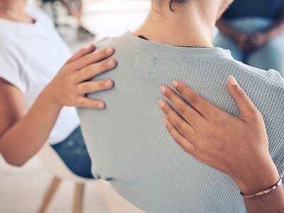 People provide support to each other in a group therapy session at a fentanyl addiction treatment center.